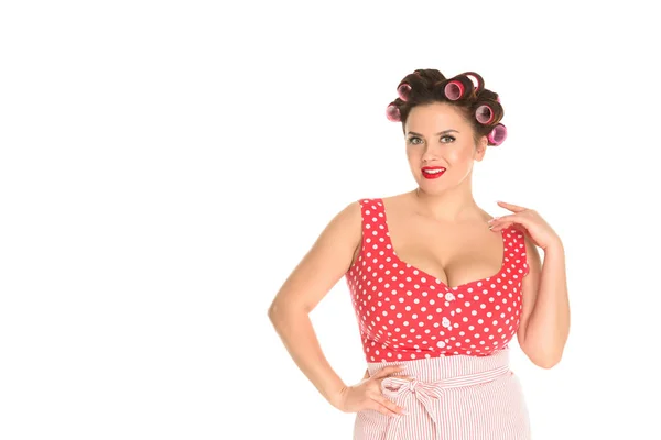 Attractive plus size housewife in red dress with curlers in hair isolated on white — Stock Photo
