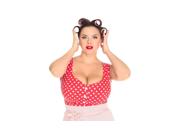 Attractive plus size woman with curlers in hair looking at camera isolated on white — Stock Photo