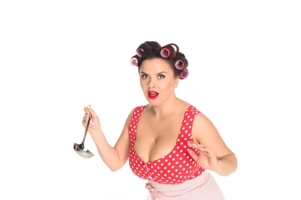 Emotional plus size housewife with ladle looking at camera isolated on white — Stock Photo