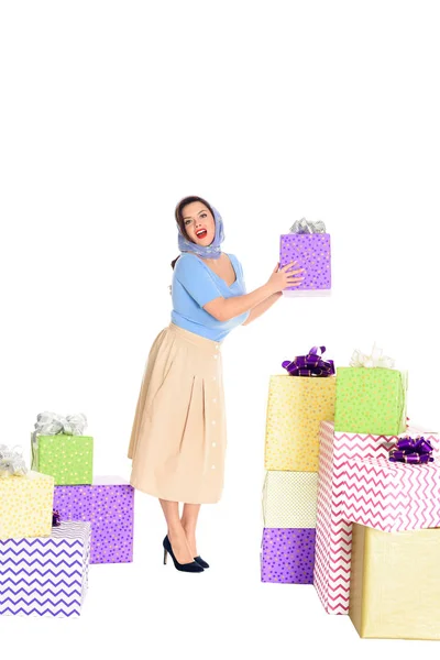 Beautiful stylish young woman holding present and looking at camera isolated on white — Stock Photo