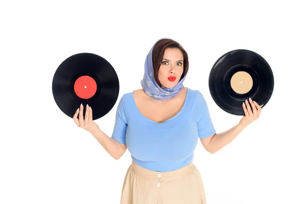 Beautiful size plus pin up woman holding vinyl records and looking at camera isolated on white — Stock Photo