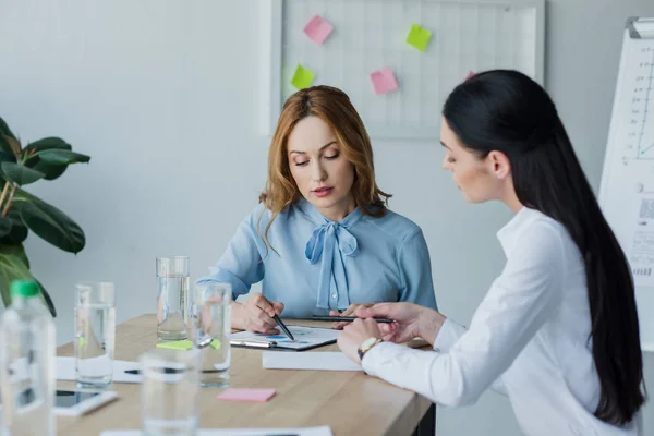 Businesswomen working on project together at workplace in office — Stock Photo