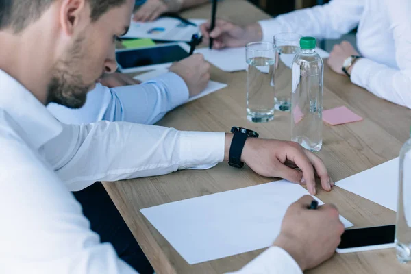 Partial view of business people at workplace with papers in office — Stock Photo