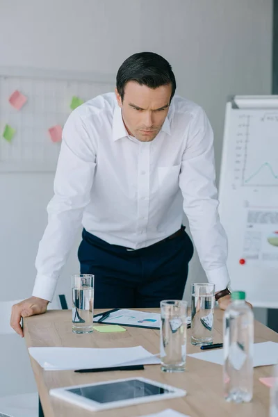 Portrait of pensive businessman in formal wear at workplace in office — Stock Photo