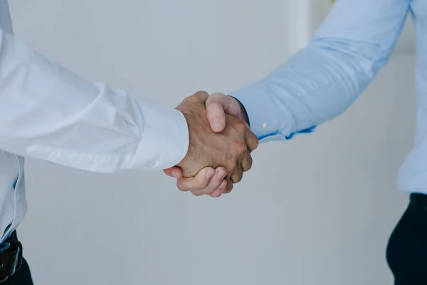 Cropped shot of businessmen shaking hands together — Stock Photo
