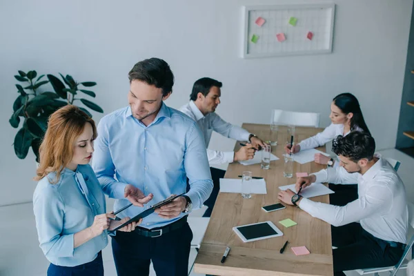 Selective focus of business coworkers having discussion during business training in office — Stock Photo