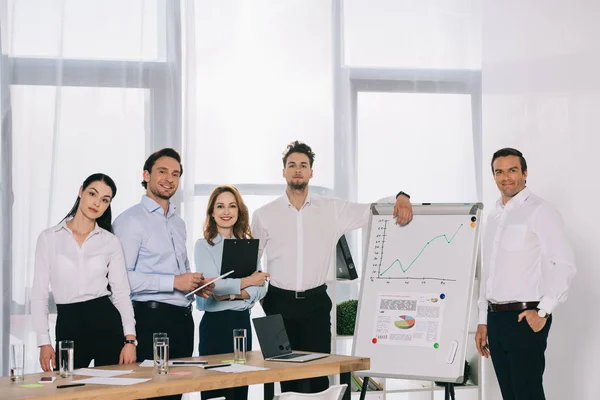 Portrait of business people after business training standing at white board in office — Stock Photo