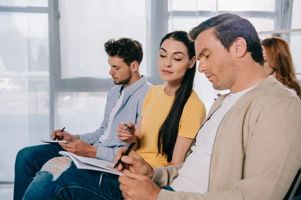 Group of business people with notebooks at business training in office — Stock Photo