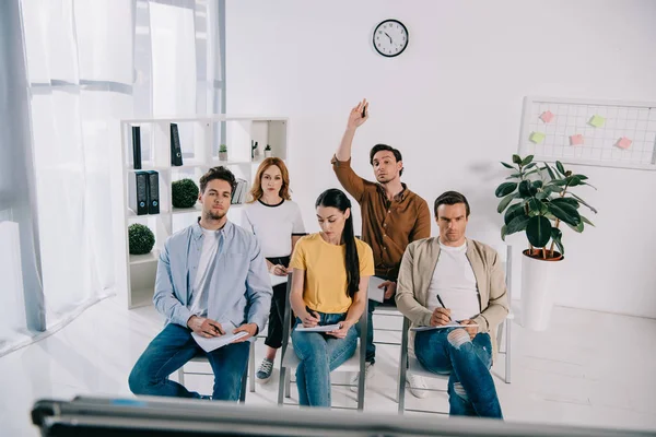 Group of business people in casual clothing with notebooks having business training in office — Stock Photo