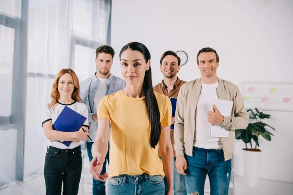 Businesswoman outstretching hand for handshake after business training in office — Stock Photo