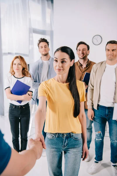 Partial view of businesswoman shaking hands with mentor after business training in office — Stock Photo