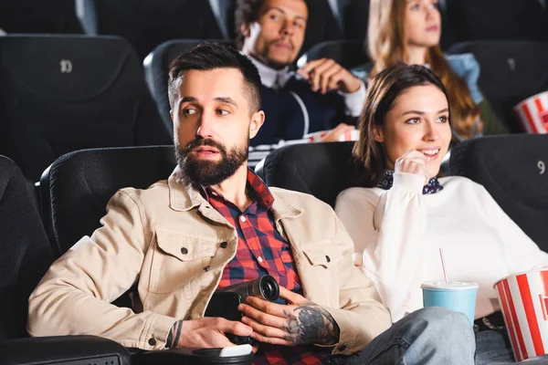 Selective focus of man shooting with digital camera and woman watching movie in cinema — Stock Photo