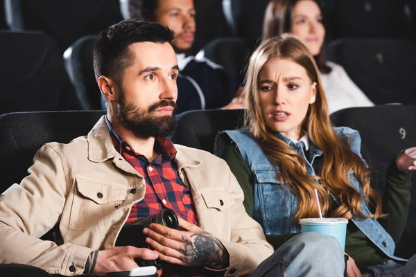 Selective focus of man shooting with digital camera and woman looking at it in cinema — Stock Photo