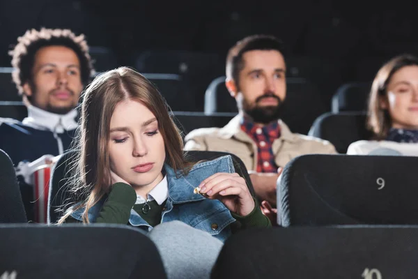 Selective focus of sad woman looking down in cinema — Stock Photo