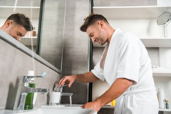 Side view of happy man in bathtub standing in bathroom — Stock Photo