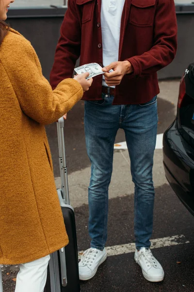 Cropped view of woman paying off with taxi driver — Stock Photo