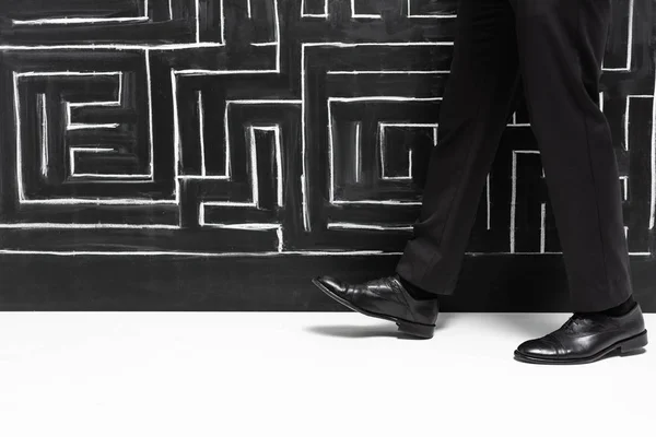 Vista recortada de hombre de negocios en desgaste formal caminando cerca de laberinto - foto de stock