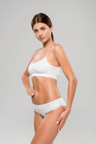 Beautiful slim woman in underwear posing isolated on grey — Stock Photo