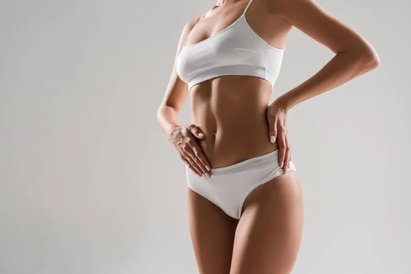 Cropped view of beautiful slim woman in underwear isolated on grey — Stock Photo