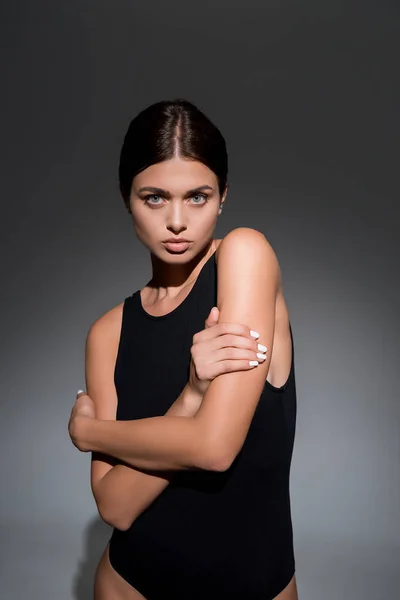 Beautiful young model posing on black background — Stock Photo