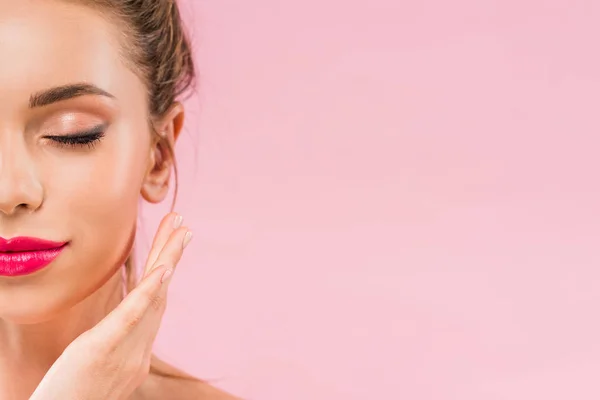 Cropped view of naked beautiful woman with pink lips posing with hand near face and closed eyes isolated on pink — Stock Photo