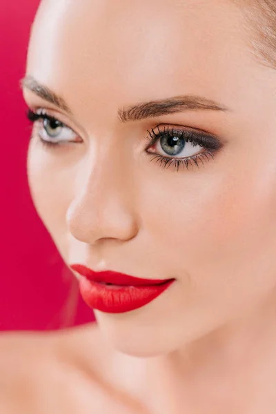 Close up view of beautiful woman with red lips isolated on red — Stock Photo