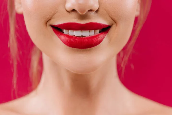 Cropped view of smiling naked beautiful woman with red lips isolated on red — Stock Photo