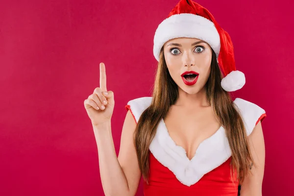 Shocked sexy beautiful santa girl showing idea gesture isolated on burgundy — Stock Photo