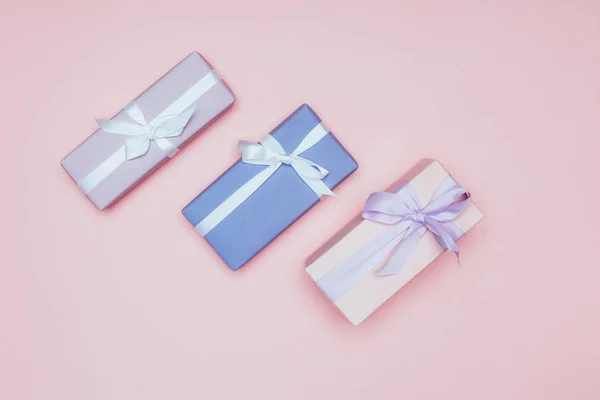 Top view of christmas gift boxes with ribbons, isolated on pink — Stock Photo