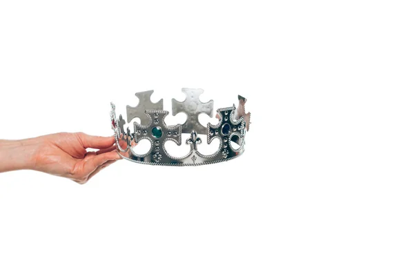 Cropped view of woman holding silver crown with gemstones, isolated on white — Stock Photo