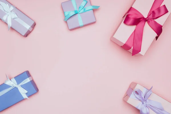 Top view of christmas gift boxes with ribbons and bows, isolated on pink — Stock Photo