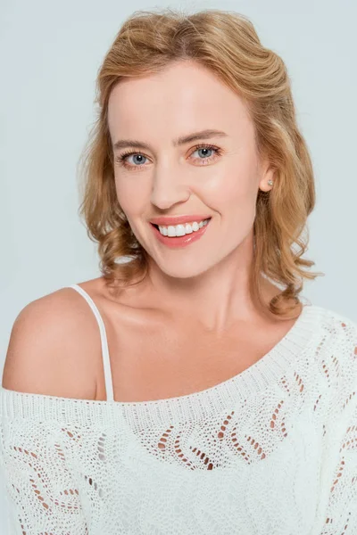 Attractive and smiling woman looking at camera isolated on grey — Stock Photo