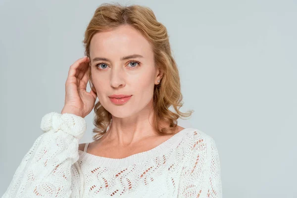 Attractive woman in sweater looking at camera isolated on grey — Stock Photo