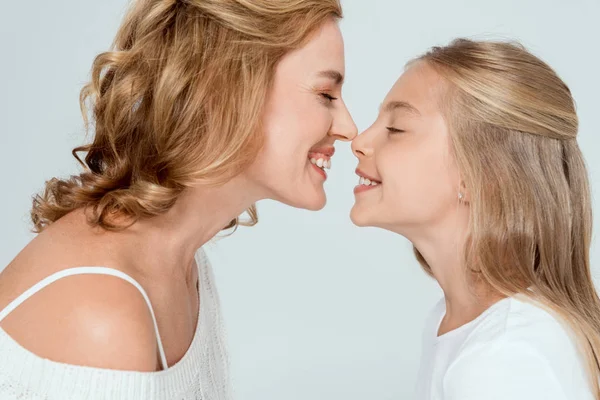 Side view of attractive mother touching nose of smiling daughter isolated on grey — Stock Photo