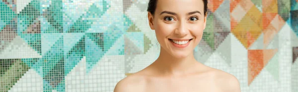 Panoramic shot of smiling and attractive woman looking at camera in spa — Stock Photo