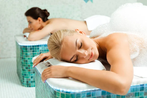 Selective focus of attractive woman with foam in Turkish bath — Stock Photo