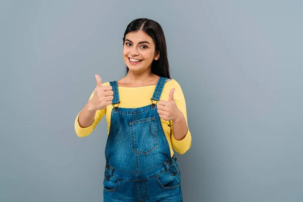 Smiling pregnant pretty girl showing thumbs up isolated on grey — Stock Photo