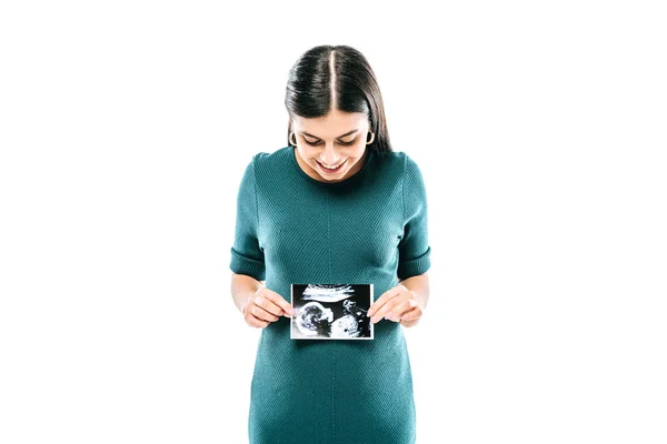 Smiling pregnant girl holding fetal ultrasound image isolated on white — Stock Photo