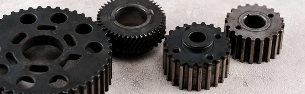 Metal round gears on grey background, panoramic shot — Stock Photo