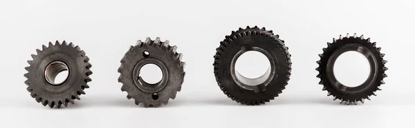 Metal round gears in row on white background, panoramic shot — Stock Photo