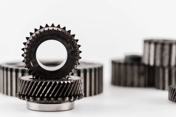 Selective focus of metal round gears on white background — Stock Photo