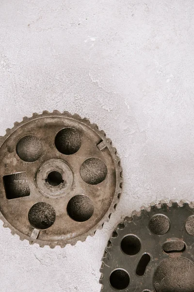 Top view of aged metal round gears on grey background — Stock Photo