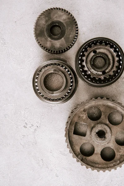 Top view of aged metal round gears on grey background — Stock Photo