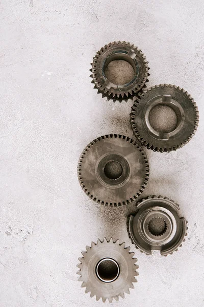 Top view of aged metal round gears on grey background — Stock Photo