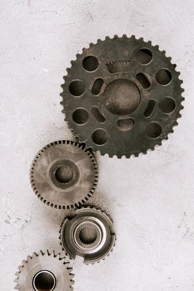 Top view of aged metal round gears on grey background — Stock Photo