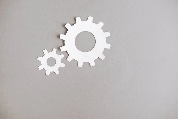 Top view of white gears on grey background — Stock Photo