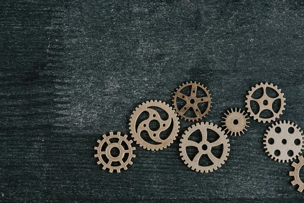 Top view of retro metal gears on dark wooden background with copy space — Stock Photo