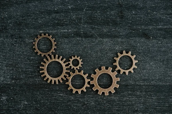 Top view of retro metal gears on dark wooden background with copy space — Stock Photo