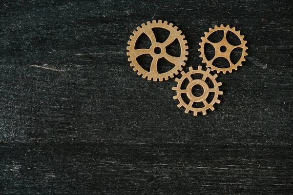 Top view of vintage metal gears on dark wooden background with copy space — Stock Photo