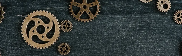 Top view of vintage metal gears on dark wooden background with copy space, panoramic shot — Stock Photo